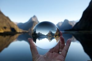 Man holding crystal ball in landscape